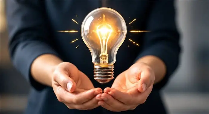 Hands holding a glowing lightbulb, symbolising a new business idea